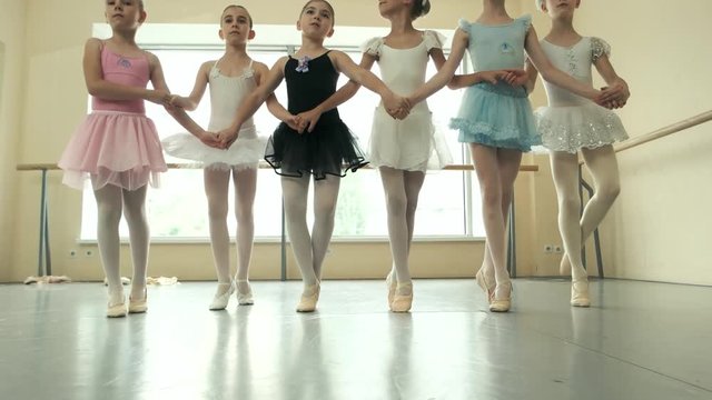 Group of ballerinas rehearsing before performance. Six little ballerinas are practicing dance together. Choreography and ballet concept.