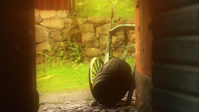 Old style, trolley and barrels traditional. Pavement sidewalks, vintage, retro style historical farm concept. Sunlight and shine.