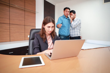 businesswoman being gossiped by male colleague in office (rumor and gossip concept).