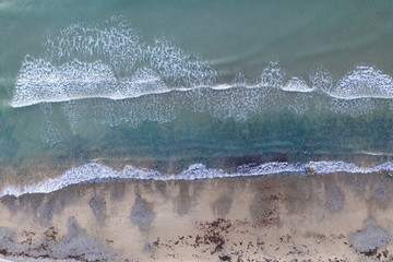 Aerial drone view of waves and beach in Wales, UK