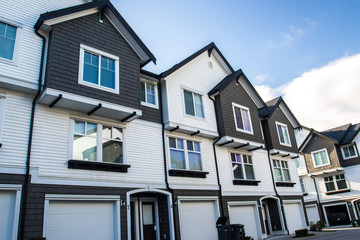 Fototapeta premium Nice and comfortable neighborhood. Townhouses in the suburbs of Canada. Booming real estate.