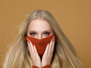 Woman in knitted sweater fashion with blonde long hair autumn stylish