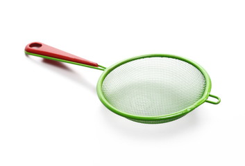 Colorful metal sieve isolated on white background