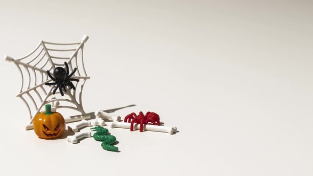 short animation, timelapse, with moving toys, for Halloween. With pumpkin, spider, cobweb, snake and bones. 4k video, 30 fps