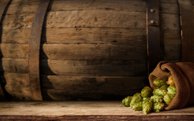 Beer barrel with beer glasses on table on wooden background