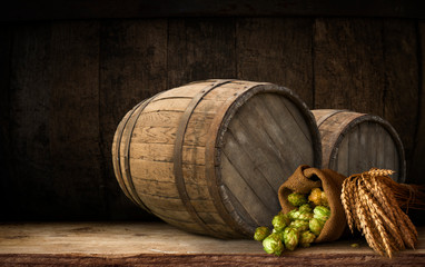 Beer barrel with beer glasses on table on wooden background