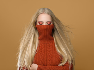 Woman in knitted sweater fashion with blonde long hair autumn stylish
