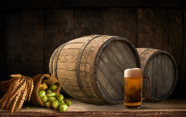 Beer barrel with beer glasses on table on wooden background