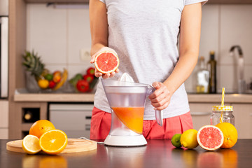 Woman using a citrus juicer