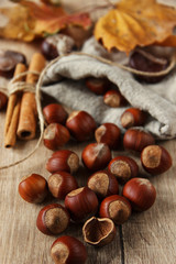 A placer of hazelnuts on a wooden background. Rustic. Christmas. Close up. Cinnamon sticks. Festive...