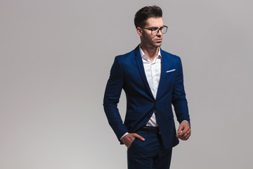 elegant fashion man in glasses looks away to side