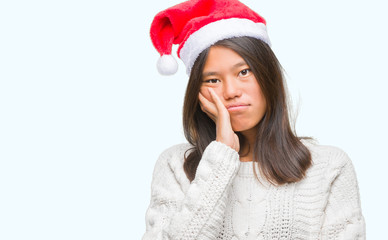 Young asian woman wearing christmas hat over isolated background thinking looking tired and bored with depression problems with crossed arms.