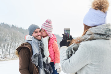 Mutter macht Foto mit dem Smartphone