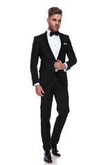 young groom opening his tuxedo