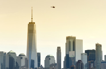 Fototapeta premium Helicopter fly over the skyscrapers of financial district in lower Manhattan, New York, USA
