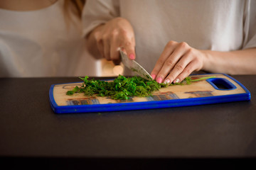 Young sisters making vegetable salad at home