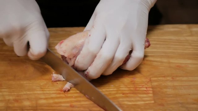 Preparation for cooking. The chef cutting the quail