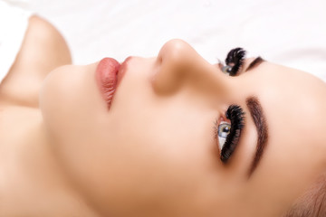 Eyelash Extension Procedure. Woman Eye with Long Eyelashes. Close up, selective focus. Hollywood, russian volume - 230405214