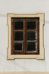 One brown window on the white wall