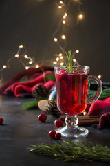 Christmas cranberry and apple mulled wine garnish rosemary and fir branches on black. Xmas drink.