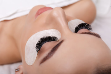 Eyelash Extension Procedure. Woman Eye with Long Eyelashes. Close up, selective focus. Hollywood, russian volume - 230405668