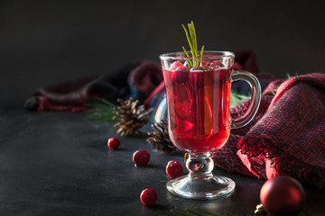 Christmas cranberry mulled wine garnish rosemary and fir branches on black. Xmas drink.