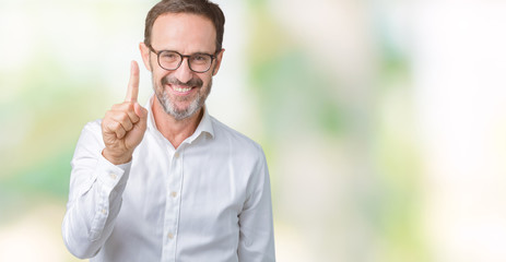Handsome middle age elegant senior business man wearing glasses over isolated background showing and pointing up with finger number one while smiling confident and happy.