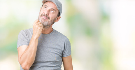 Handsome middle age hoary senior man wearing sport cap over isolated background with hand on chin thinking about question, pensive expression. Smiling with thoughtful face. Doubt concept.