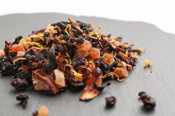 Still life, aromatic dry tea with fruits and petals