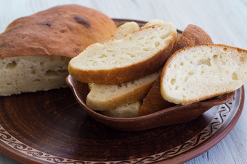 Homemade bread on a ceramic dish. Bread for traditional breakfast. Close-up. Top view