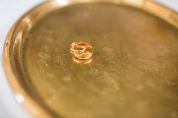 Two golden wedding rings isolated background concept