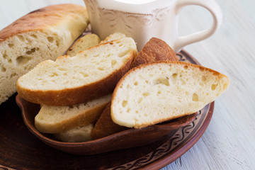 Homemade bread on a ceramic dish. Bread for traditional breakfast. Close-up.