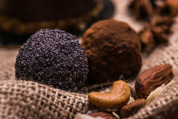 Candy close-up on the fabric. Chocolates with poppy seeds and nuts.