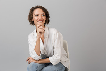 Business woman posing isolated over grey wall