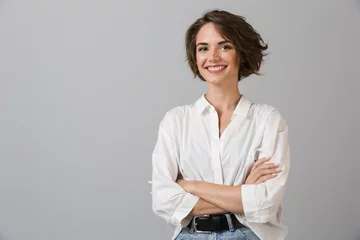 Foto op Plexiglas Happy young business woman posing isolated over grey wall background. © Drobot Dean