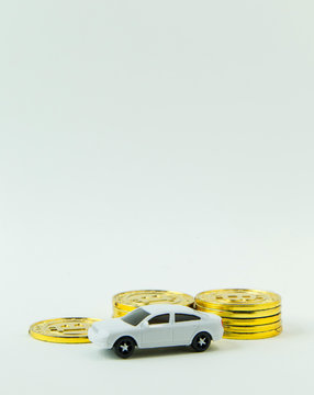 white car toy and gold coin on  white background.
