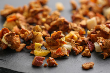 Still life, aromatic dry tea with fruits and petals