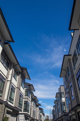 Obraz premium Rows of townhomes side by side. External facade of a row of colorful modern urban townhouses. brand new houses just after construction on real estate market.