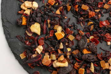 Still life, aromatic dry tea with fruits and petals