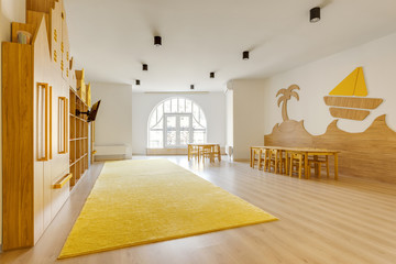 cozy light classroom with wooden furniture in modern kindergarten - obrazy, fototapety, plakaty