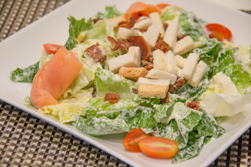 Caesar salad with salmon and parmesan cheese