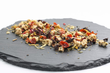 Still life, aromatic dry tea with fruits and petals