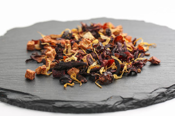 Still life, aromatic dry tea with fruits and petals