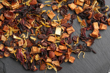 Still life, aromatic dry tea with fruits and petals