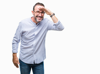 Middle age hoary senior man wearing glasses over isolated background very happy and smiling looking far away with hand over head. Searching concept.