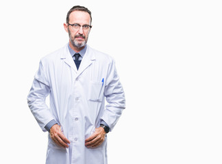 Middle age senior hoary professional man wearing white coat over isolated background with serious expression on face. Simple and natural looking at the camera.