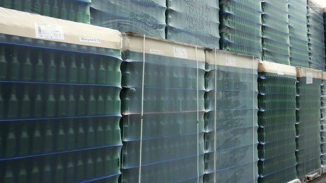 A lot of wrapped empty beer bottles on pallets
