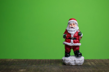Close up of santa claus and a sled isolated on green backround