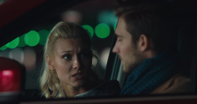 Young adult Caucasian couple or family having a quarrel a modern SUV. 4K UHD 60 FPS SLOW MOTION