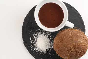 close up of cup of hot chocolate and coconut